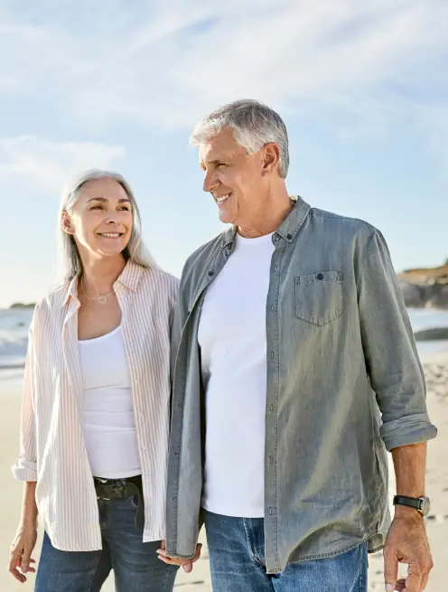 older couple walking on beach