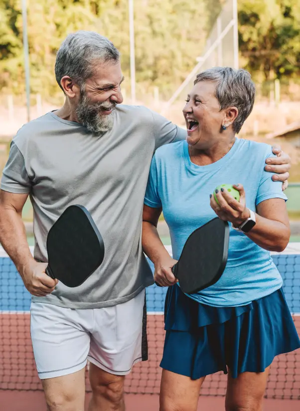 older couple walking off Pickleball court