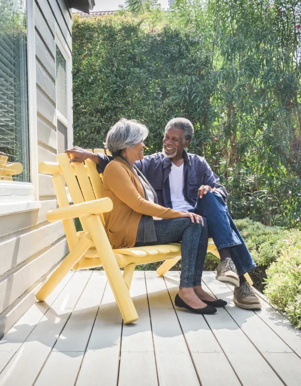 older couple sitting on patio bench
