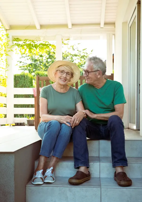old couple sitting on porch bench