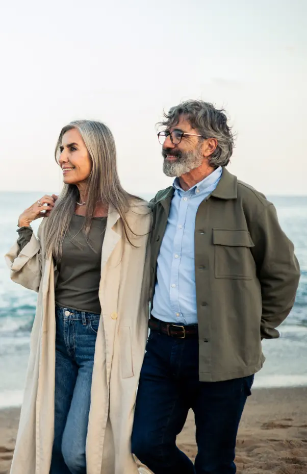 older couple walking on beach